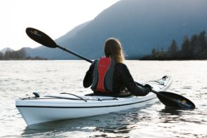 woman kayaking on a lake