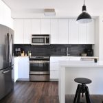Kitchen with dark wood floors and white cabinets