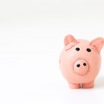 Image of a pink piggy bank in the right hand corner against a white background