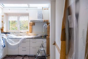 Image of a home renovation in a kitchen with white cupboards