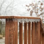 Image of icicles forming along the edge of a wooden deck railing