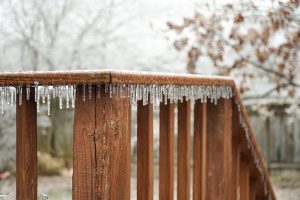 Image of icicles forming along the edge of a wooden deck railing