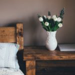 Image of a bed and a vase of tulips, spring home décor