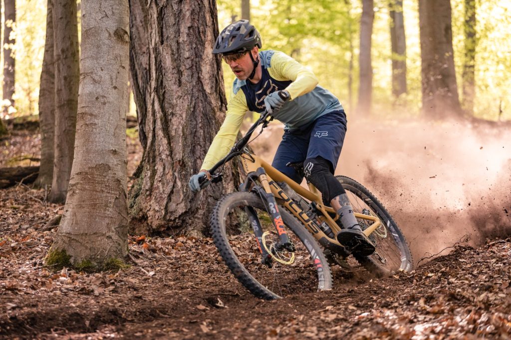 Image of a person mountain biking on a dirt trail 